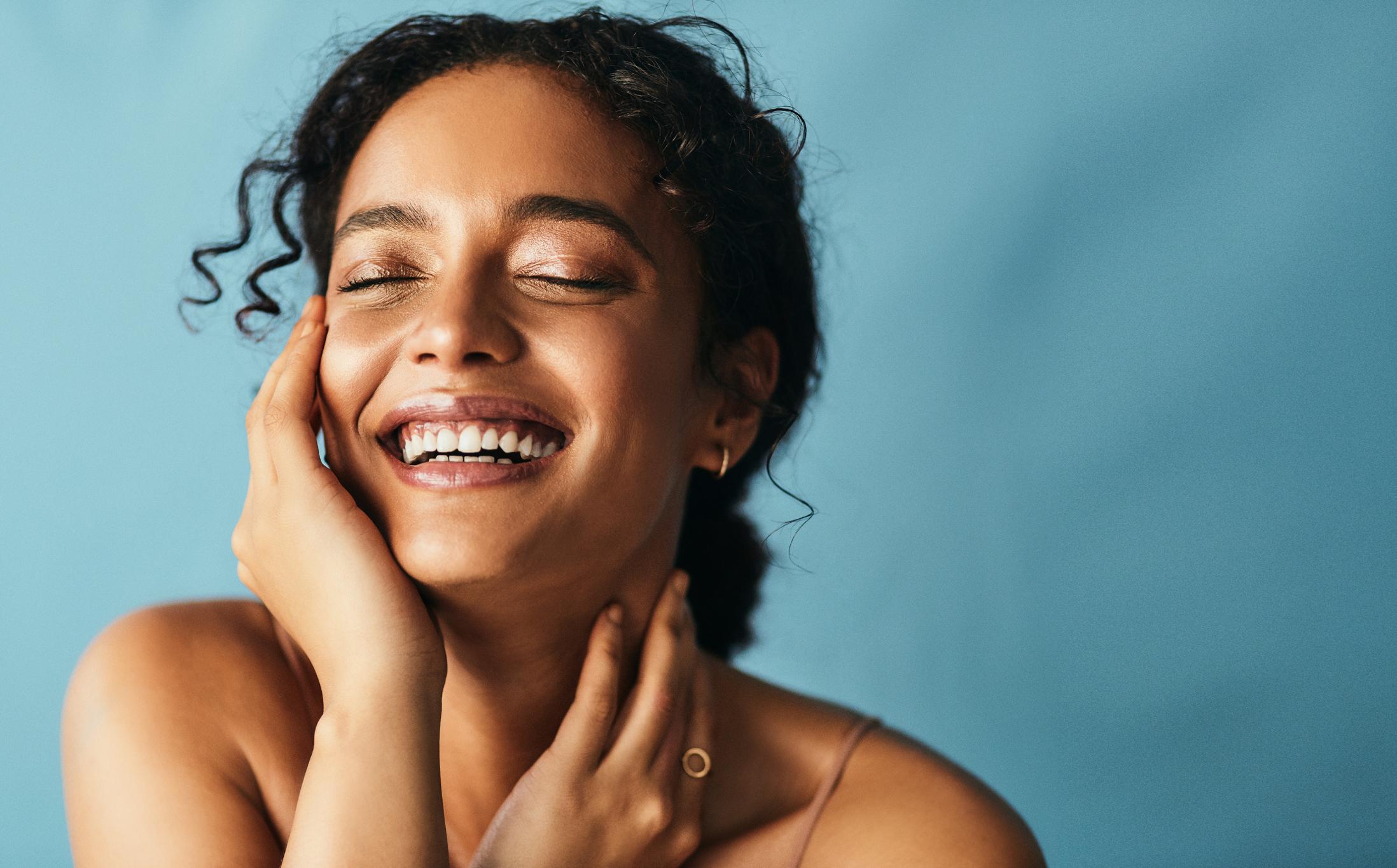 Close-up portrait of a smiling client with glowing, refreshed skin